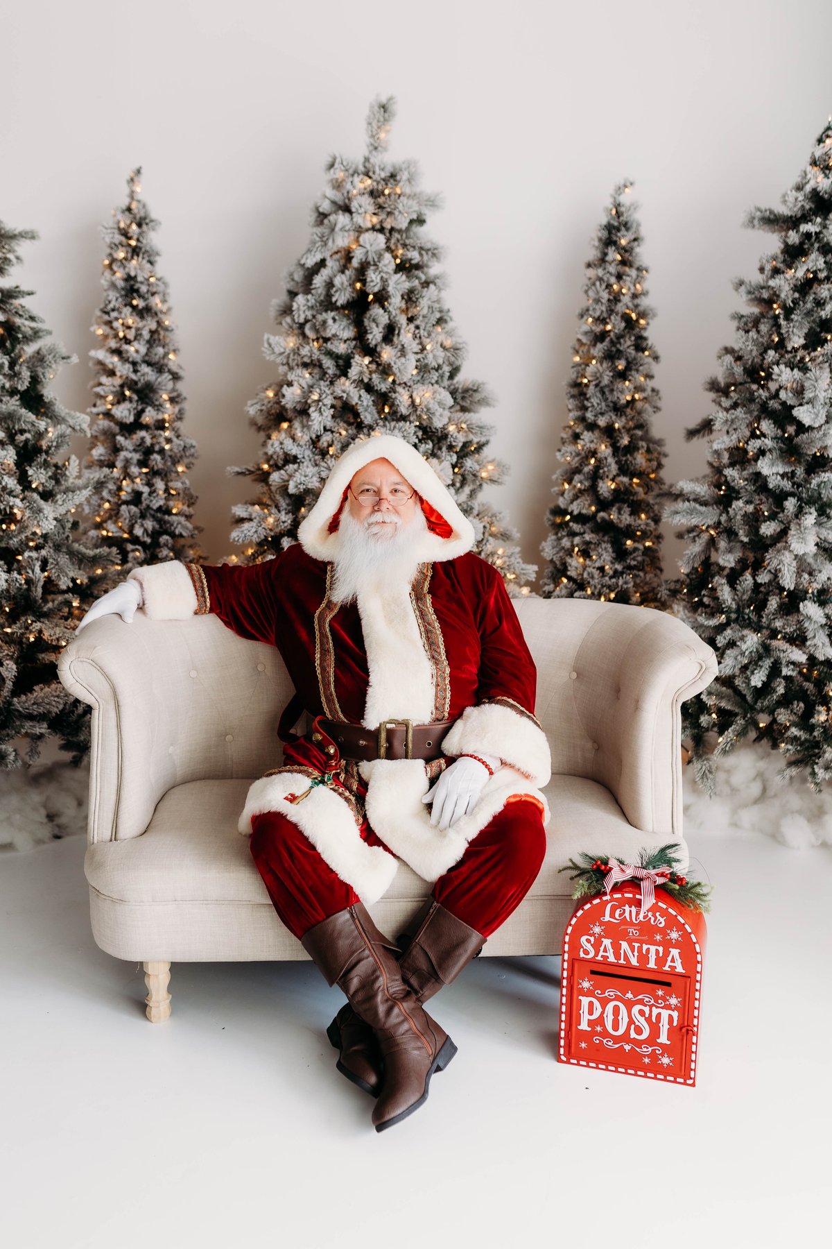 Gregg da Santa smiling by a Letters to Santa mailbox